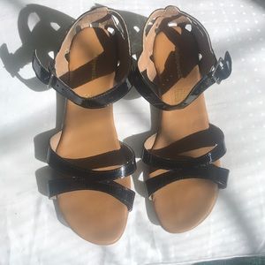 Kids express black sandals.